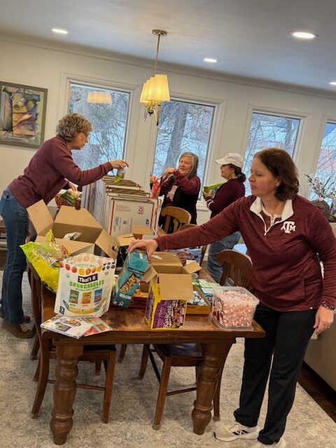 Aggie Moms assembling care packages for Aggie students.